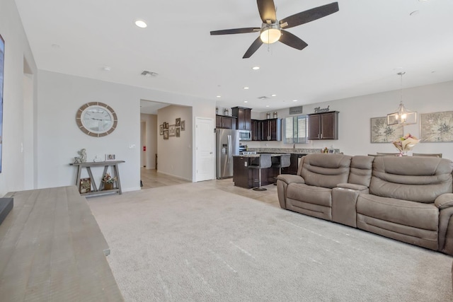 1066 Jade Way, Lemoore, CA 93245 - living area featuring a ceiling fan, light colored carpet, and recessed lighting