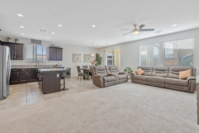 1066 Jade Way, Lemoore, CA 93245 - living room with light tile patterned floors, recessed lighting, a ceiling fan, and light carpet