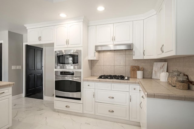 8501 N Akron Ave, Fresno, CA 93720 - kitchen with stainless steel appliances, light marble finish flooring, white cabinets, recessed lighting, and backsplash