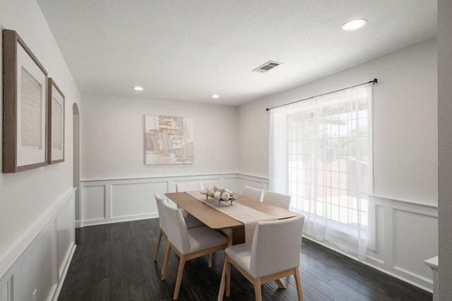 8501 N Akron Ave, Fresno, CA 93720 - dining room with a decorative wall, dark wood-style flooring, wainscoting, recessed lighting, and arched walkways