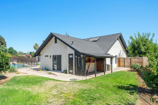 8501 N Akron Ave, Fresno, CA 93720 - rear view of house with stucco siding, solar panels, a patio, and a fenced backyard