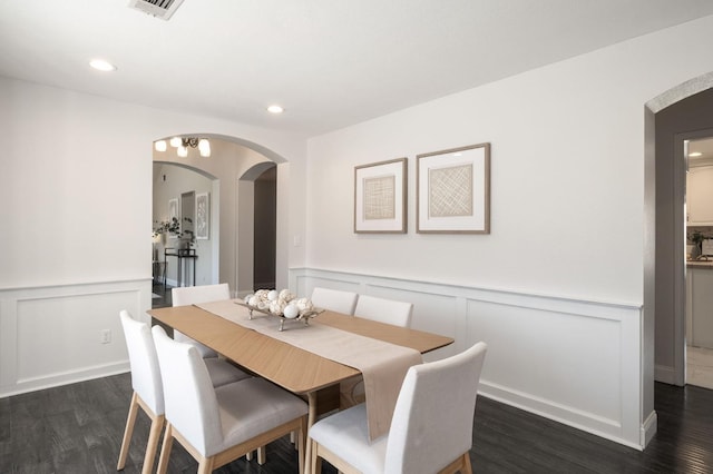 8501 N Akron Ave, Fresno, CA 93720 - dining space featuring arched walkways, a decorative wall, dark wood-style flooring, wainscoting, and recessed lighting