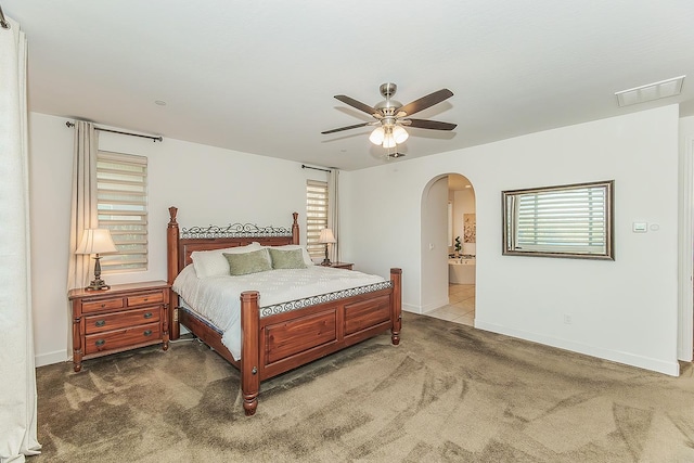 400 Ridge Creek Estates Way, Dinuba, CA 93618 - bedroom with arched walkways, carpet floors, multiple windows, and ceiling fan