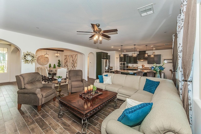 400 Ridge Creek Estates Way, Dinuba, CA 93618 - living area featuring arched walkways, ceiling fan, and dark wood-style flooring