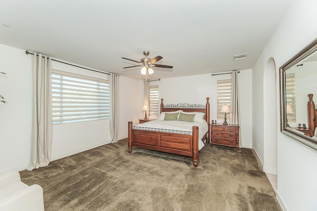 400 Ridge Creek Estates Way, Dinuba, CA 93618 - bedroom with dark carpet, arched walkways, and a ceiling fan