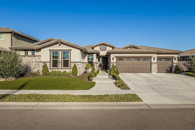 400 Ridge Creek Estates Way, Dinuba, CA 93618 - view of front of house featuring concrete driveway, an attached garage, a front yard, stucco siding, and stone siding
