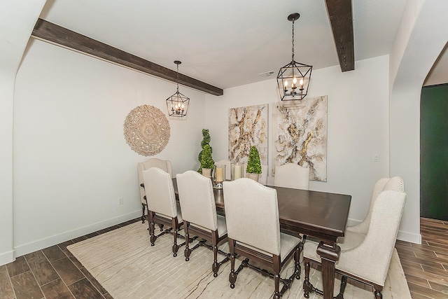 400 Ridge Creek Estates Way, Dinuba, CA 93618 - dining area featuring a chandelier, beam ceiling, wood finished floors, and arched walkways