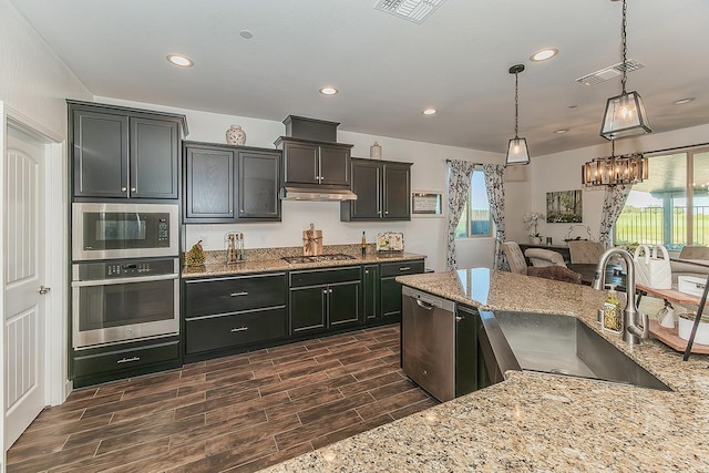 400 Ridge Creek Estates Way, Dinuba, CA 93618 - kitchen featuring appliances with stainless steel finishes, light stone counters, dark wood finished floors, hanging light fixtures, and recessed lighting