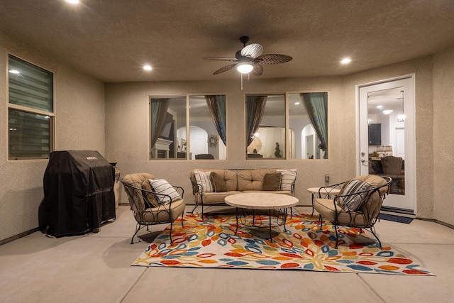 400 Ridge Creek Estates Way, Dinuba, CA 93618 - living area featuring a textured wall, unfinished concrete floors, a ceiling fan, and recessed lighting