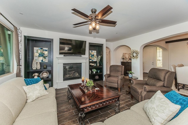 400 Ridge Creek Estates Way, Dinuba, CA 93618 - living room with arched walkways, ceiling fan, wood finished floors, and a glass covered fireplace