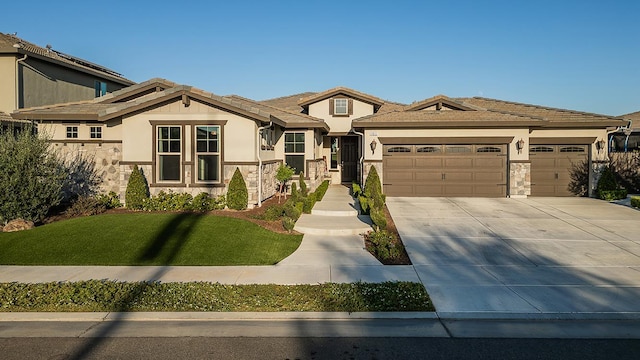 400 Ridge Creek Estates Way, Dinuba, CA 93618 - view of front facade featuring stone siding, a garage, concrete driveway, a front lawn, and stucco siding