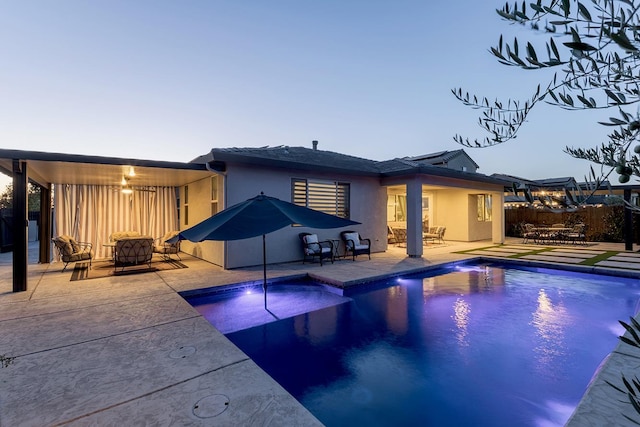 400 Ridge Creek Estates Way, Dinuba, CA 93618 - rear view of house featuring stucco siding, a patio, an outdoor living space, and outdoor dining area