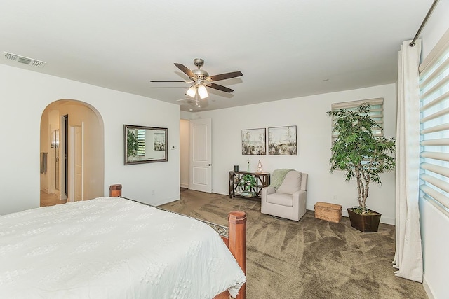 400 Ridge Creek Estates Way, Dinuba, CA 93618 - carpeted bedroom featuring arched walkways, multiple windows, and a ceiling fan