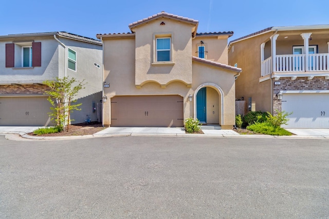 915 Winchell Way W, Madera, CA 93636 - view of front of home with stucco siding, an attached garage, and a tile roof