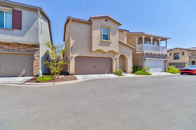 915 Winchell Way W, Madera, CA 93636 - view of front of house featuring stucco siding, an attached garage, and a balcony