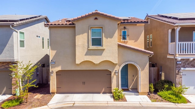 915 Winchell Way W, Madera, CA 93636 - mediterranean / spanish house with stucco siding, a tile roof, and an attached garage