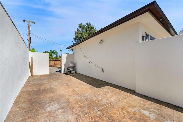 652 E Portals Ave, Fresno, CA 93710 - view of side of property featuring stucco siding and a patio area
