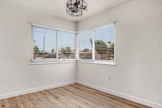 652 E Portals Ave, Fresno, CA 93710 - empty room featuring healthy amount of natural light, light wood-style floors, and a chandelier