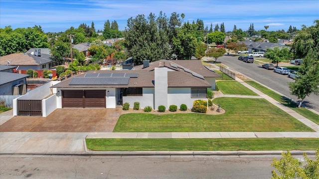 652 E Portals Ave, Fresno, CA 93710 - view of front of house featuring an attached garage, roof mounted solar panels, a residential view, concrete driveway, and stucco siding