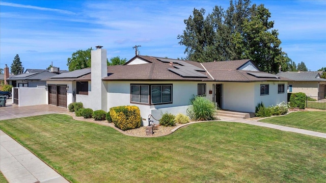 652 E Portals Ave, Fresno, CA 93710 - ranch-style home with a garage, driveway, roof mounted solar panels, and stucco siding