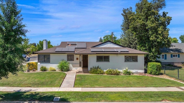 652 E Portals Ave, Fresno, CA 93710 - view of front facade featuring roof mounted solar panels, stucco siding, a chimney, and a shingled roof