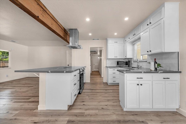 652 E Portals Ave, Fresno, CA 93710 - kitchen featuring ventilation hood, a peninsula, plenty of natural light, white cabinets, and recessed lighting