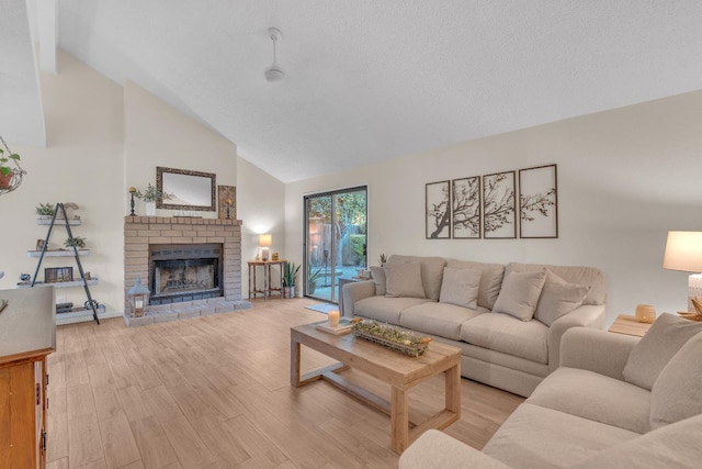 1750 E Deyoung, Fresno, CA 93720 - living room with a fireplace, light wood-type flooring, and high vaulted ceiling