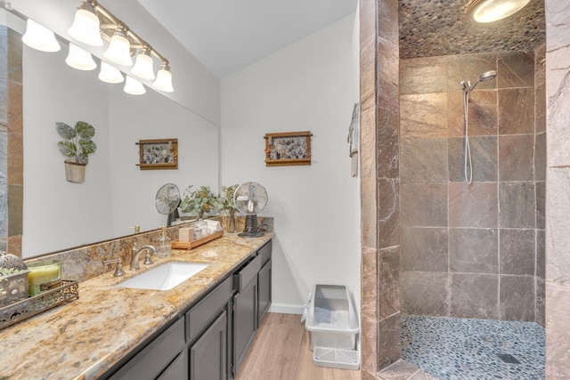 1750 E Deyoung, Fresno, CA 93720 - bathroom featuring a tile shower, vanity, wood finished floors, and lofted ceiling