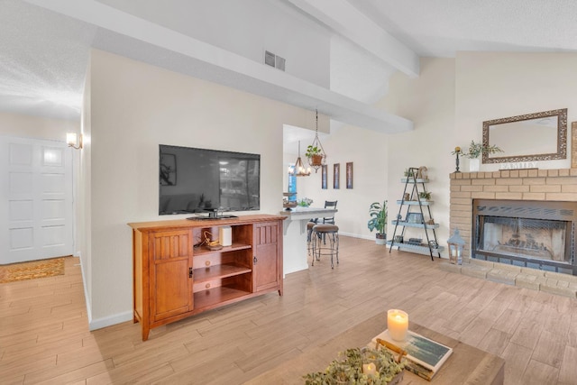 1750 E Deyoung, Fresno, CA 93720 - living area featuring light wood finished floors, a fireplace, and a chandelier