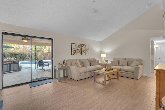 1750 E Deyoung, Fresno, CA 93720 - living area featuring vaulted ceiling, light wood-style floors, and a textured ceiling