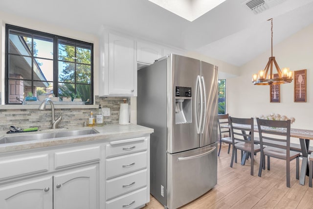 1750 E Deyoung, Fresno, CA 93720 - kitchen featuring stainless steel fridge with ice dispenser, tasteful backsplash, a chandelier, white cabinetry, and light countertops