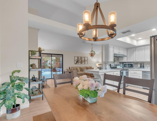 1750 E Deyoung, Fresno, CA 93720 - dining area featuring a chandelier, light wood finished floors, recessed lighting, a raised ceiling, and a high ceiling