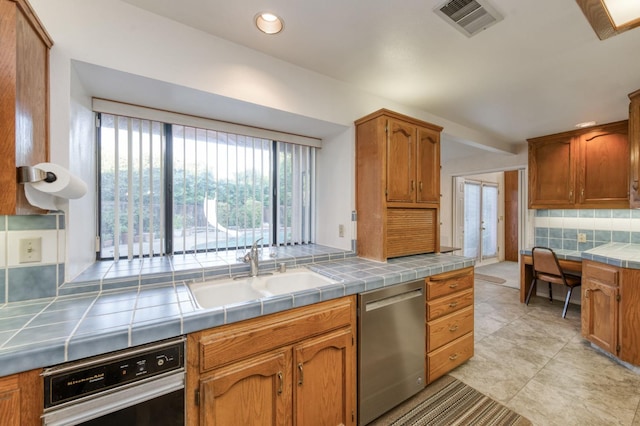 7664 N Kavanagh Ave, Fresno, CA 93711 - kitchen featuring stainless steel dishwasher, tile counters, tasteful backsplash, brown cabinets, and recessed lighting