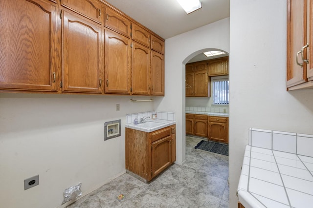 7664 N Kavanagh Ave, Fresno, CA 93711 - washroom with electric dryer hookup, cabinet space, washer hookup, and arched walkways