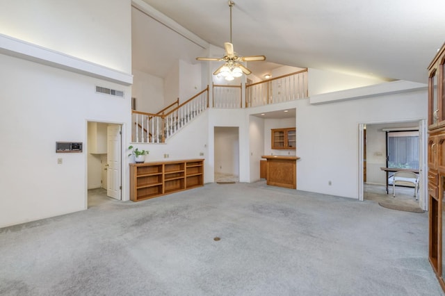 7664 N Kavanagh Ave, Fresno, CA 93711 - unfurnished living room featuring carpet, high vaulted ceiling, ceiling fan, and stairs