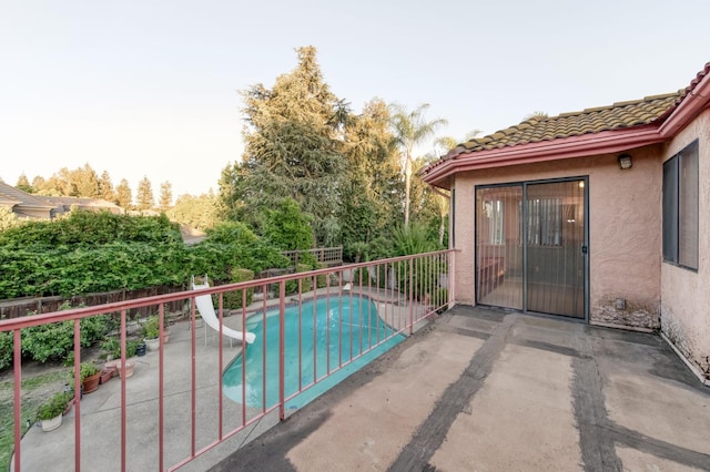 7664 N Kavanagh Ave, Fresno, CA 93711 - view of swimming pool with a water slide, a fenced backyard, and a patio area