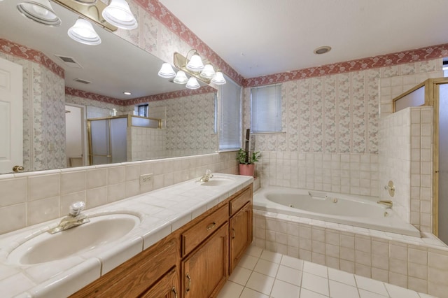 7664 N Kavanagh Ave, Fresno, CA 93711 - bathroom with tile patterned floors, a bath, double vanity, a stall shower, and tile walls