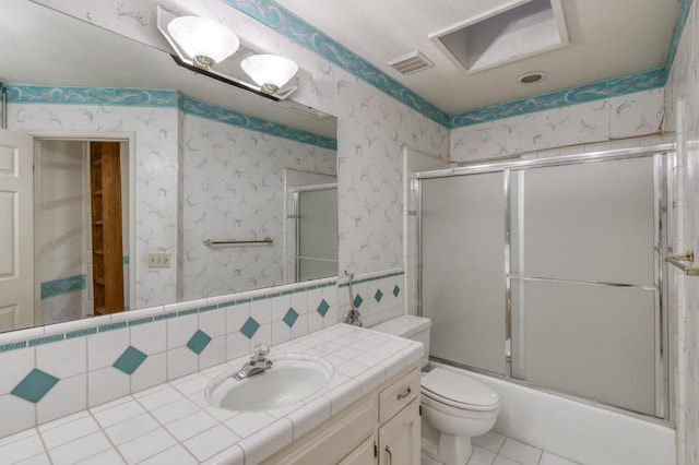7664 N Kavanagh Ave, Fresno, CA 93711 - bathroom featuring vanity, enclosed tub / shower combo, tile patterned floors, and wallpapered walls