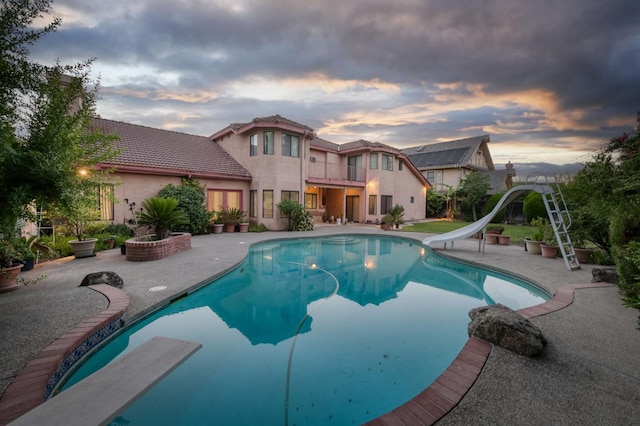 7664 N Kavanagh Ave, Fresno, CA 93711 - outdoor pool featuring a water slide, a diving board, and a patio area
