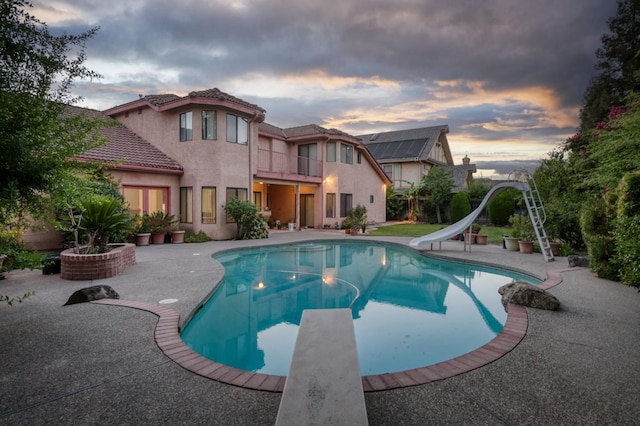 7664 N Kavanagh Ave, Fresno, CA 93711 - outdoor pool with a water slide, a diving board, and a patio area