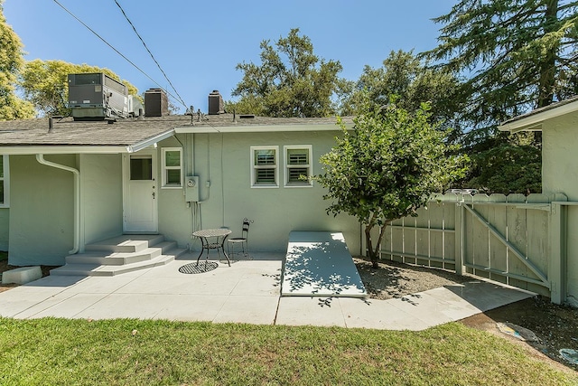 4845 Arcade Ave, Fresno, CA 93704 - rear view of house with stucco siding, a chimney, a patio area, and roof with shingles