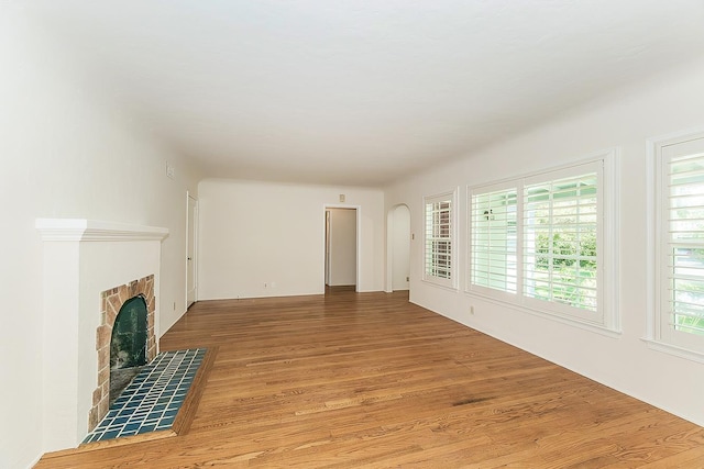 4845 Arcade Ave, Fresno, CA 93704 - unfurnished living room featuring light wood-style floors and a fireplace