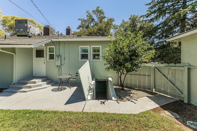 4845 Arcade Ave, Fresno, CA 93704 - rear view of house featuring stucco siding, a chimney, and a gate