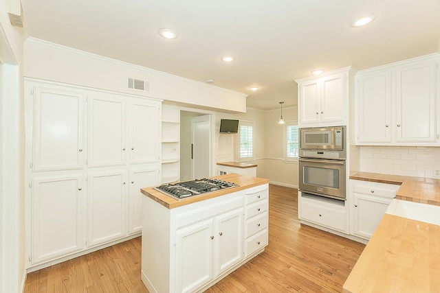 4845 Arcade Ave, Fresno, CA 93704 - kitchen with appliances with stainless steel finishes, wood counters, open shelves, light wood finished floors, and white cabinets