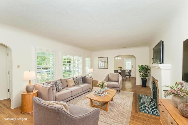 4845 Arcade Ave, Fresno, CA 93704 - living area featuring arched walkways and light wood finished floors