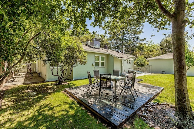 4845 Arcade Ave, Fresno, CA 93704 - rear view of property with a wooden deck, a fenced backyard, outdoor dining space, and stucco siding