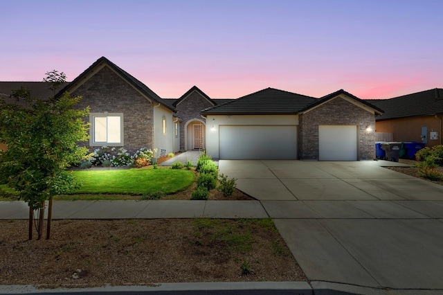 2421 N Cabrenet Pl, Hanford, CA 93230 - view of front of home with a garage, stone siding, concrete driveway, and a front yard