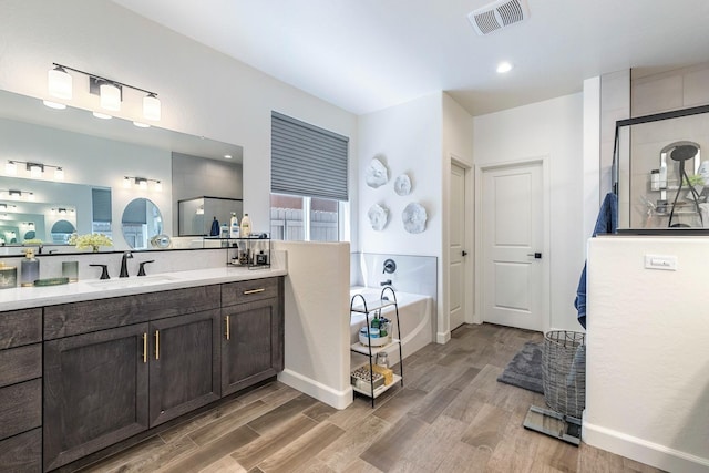2421 N Cabrenet Pl, Hanford, CA 93230 - bathroom with vanity, a garden tub, wood finished floors, and a shower