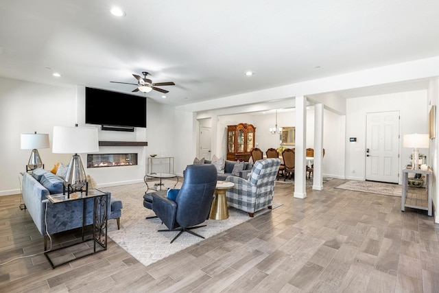 2421 N Cabrenet Pl, Hanford, CA 93230 - living area with ceiling fan, light wood-style floors, recessed lighting, and a glass covered fireplace