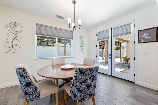 2421 N Cabrenet Pl, Hanford, CA 93230 - dining space with french doors, wood finished floors, and a chandelier